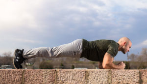 Man doing a plank exercise at an outdoor gym